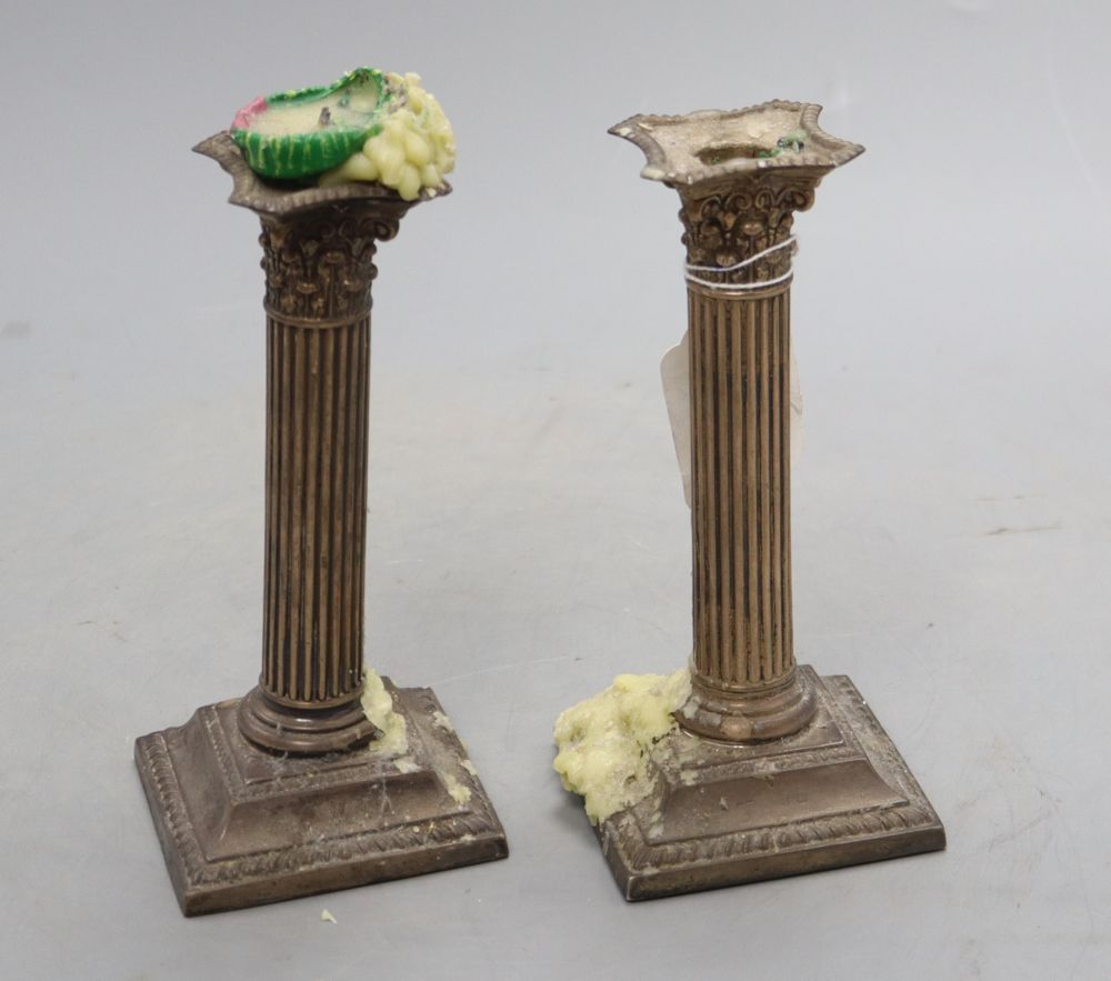 A pair of late Victorian silver corinthian column dwarf candlesticks, Birmingham, 1897, 17cm, weighted.